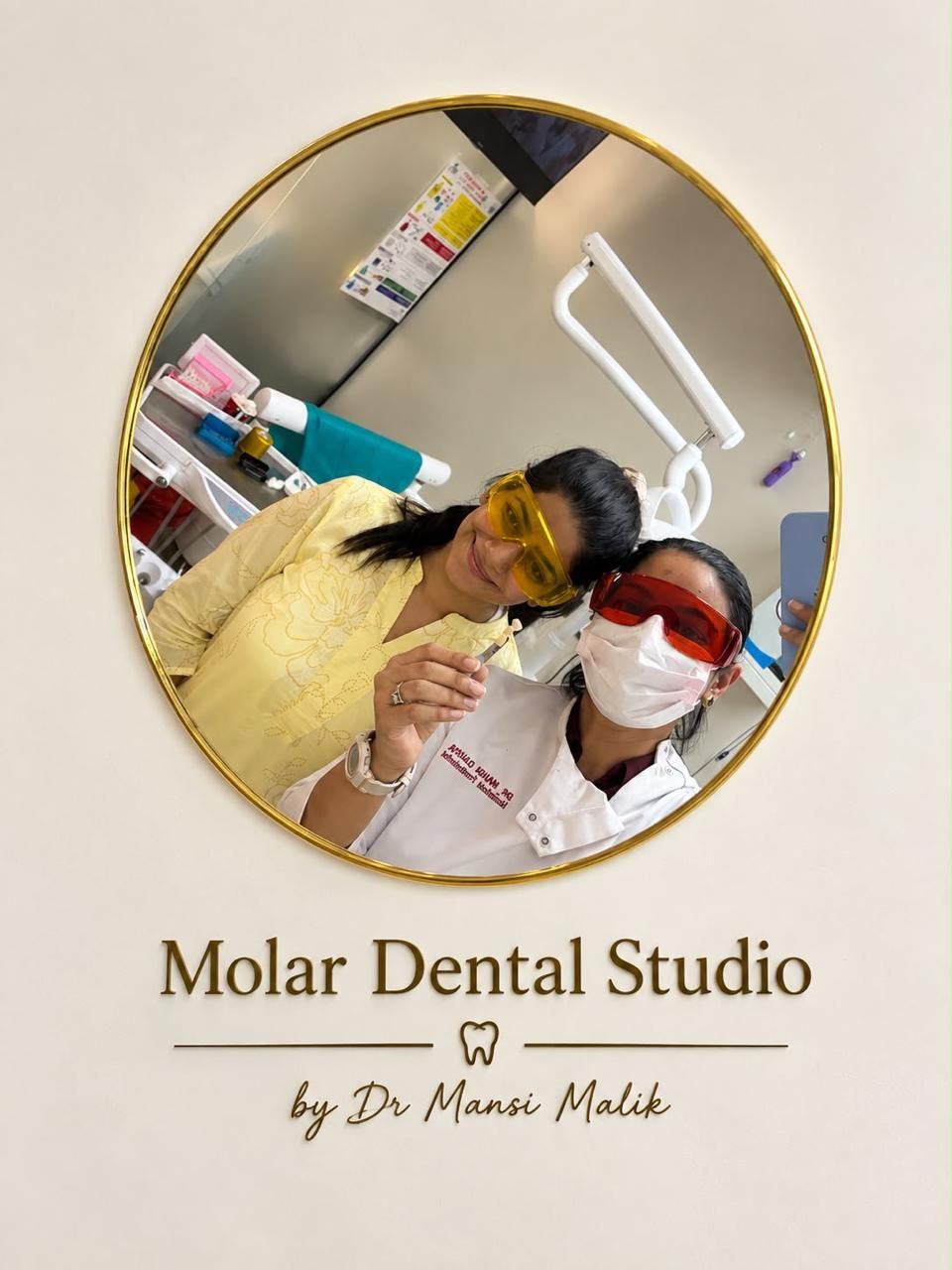 Molar Dental Studio by Dr. Mansi Malik, the studio mark over a chairside photograph