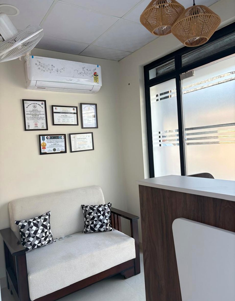 Reception and waiting area at Molar Dental Studio with framed qualifications on the wall